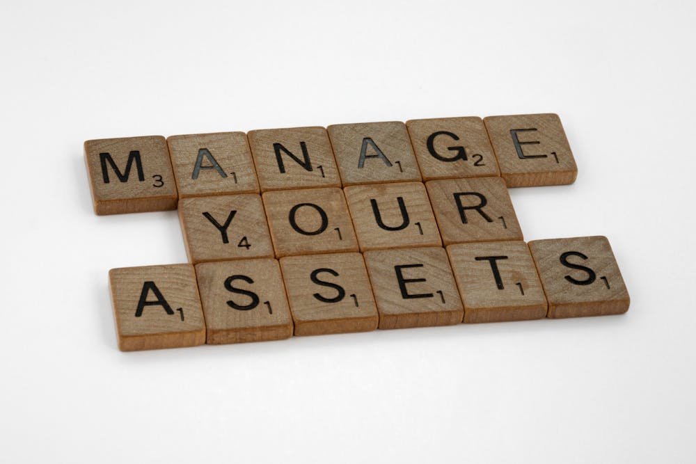 manage your assets written on small wooden tiles